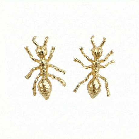 Gold ant-shaped earrings on a white background. Made in Stockholm