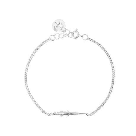 A silver-colored bracelet with a mini alligator. hancrafted in Stockholm