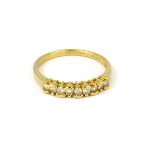 An 18K gold ring featuring a row of sparkling diamonds.