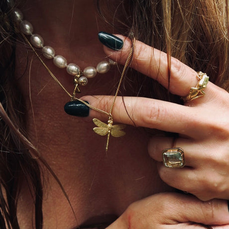 Model wearing nature-inspired statement jewelry by Carolinne B for one kiss away collection