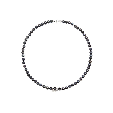A sculptural chameleon necklace set with deep black pearls, symbolizing transformation and quiet power. Handcrafted in Stockholm, this statement piece blends wild nature with refined luxury—designed to evolve with you.