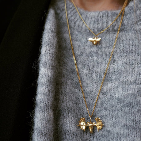 Model wearing Moose Necklace, luxury Stockholm jewelry, Scandinavian animal-inspired statement necklace by Carolinne B