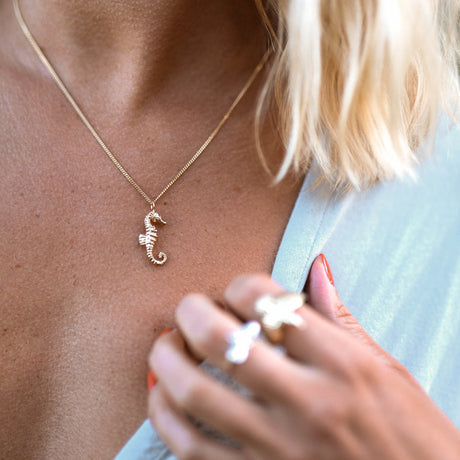 Seahorse Necklace worn – ocean inspired necklace on model by Carolinne B