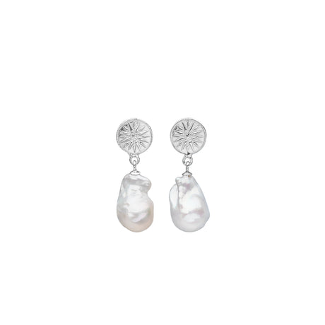 A pair of silver earrings featuring a small sun charm attached to a drop-shaped freshwater pearl. Bloom With Love by Carolinne B