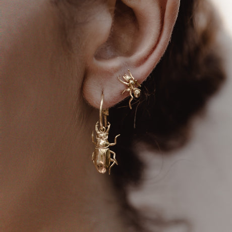 Model wearing silver ant earrings, whimsical nature-inspired jewelry by Carolinne B