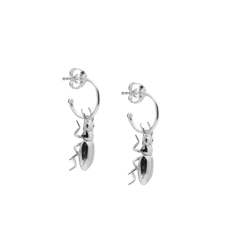 A pair of small, silver hoop earrings with a detailed beetle design attached to the hoop, displayed against a white background. designed by Carolinne B jewelry 